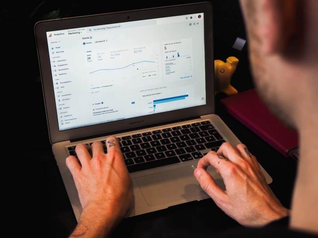 A person using Google Analytics to analyze user behavior and search patterns
